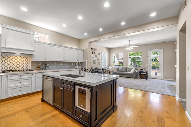 2143 Everglade Ave, Clovis, CA 93619 - kitchen with white cabinetry, gas cooktop, dark brown cabinets, backsplash, and a ceiling fan
