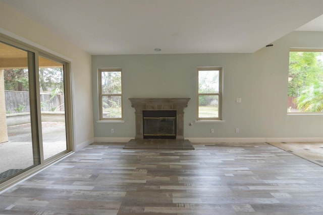 10521 N Doheny Ave, Fresno, CA 93730 - unfurnished living room with wood finished floors and a glass covered fireplace