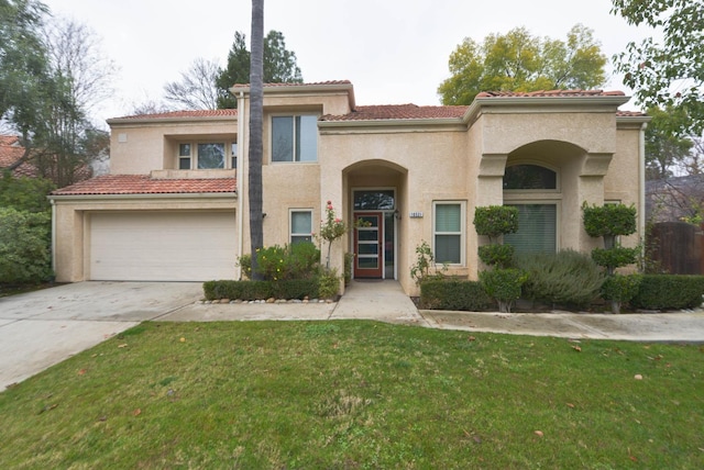 10521 N Doheny Ave, Fresno, CA 93730 - mediterranean / spanish-style house with stucco siding, concrete driveway, a front lawn, and a tile roof