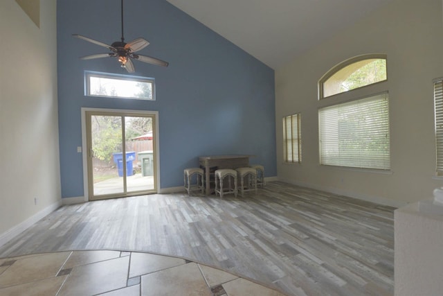 10521 N Doheny Ave, Fresno, CA 93730 - unfurnished living room with high vaulted ceiling, wood finished floors, and a ceiling fan