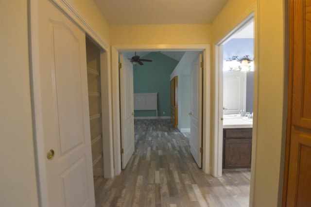 10521 N Doheny Ave, Fresno, CA 93730 - corridor featuring wood finished floors and vaulted ceiling