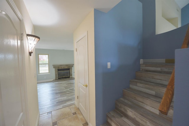 10521 N Doheny Ave, Fresno, CA 93730 - staircase featuring a high end fireplace and stone finish flooring
