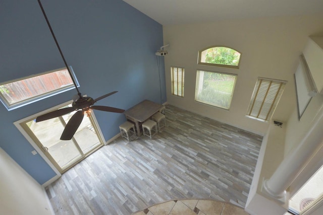 10521 N Doheny Ave, Fresno, CA 93730 - unfurnished living room featuring a ceiling fan, high vaulted ceiling, and wood finished floors