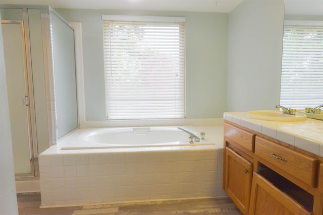 10521 N Doheny Ave, Fresno, CA 93730 - full bath with a stall shower, a bath, wood finished floors, and vanity