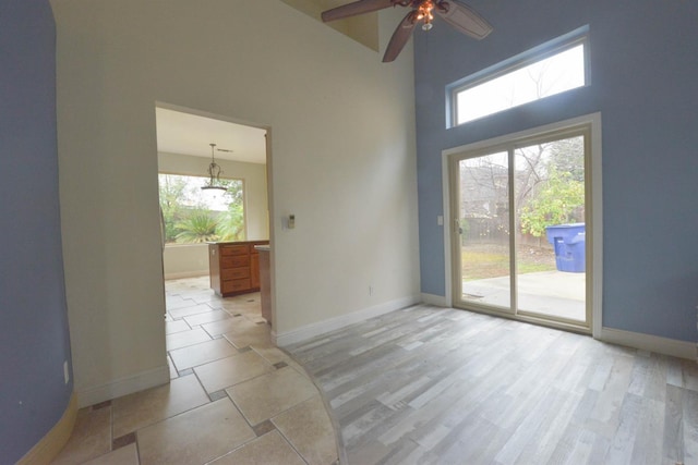 10521 N Doheny Ave, Fresno, CA 93730 - unfurnished room with ceiling fan, a high ceiling, and light wood-style flooring