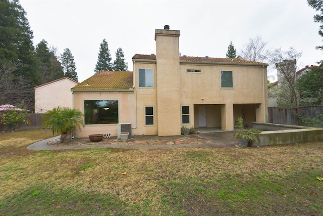 10521 N Doheny Ave, Fresno, CA 93730 - back of house with a chimney, a fenced backyard, a patio area, and stucco siding