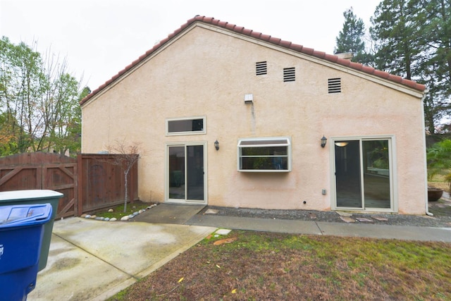 10521 N Doheny Ave, Fresno, CA 93730 - rear view of house with stucco siding, a tile roof, a patio area, and a gate