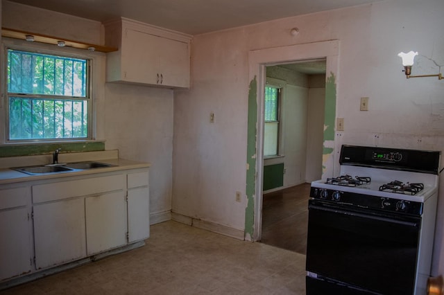 1439 S 4 Th St, Fresno, CA 93702 - kitchen featuring gas range, white cabinets, light countertops, and light flooring