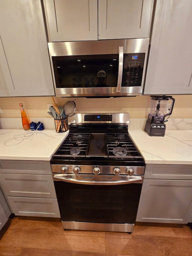 525 N Crenshaw, Visalia, CA 93291 - kitchen with stainless steel appliances, light stone countertops, and light wood-type flooring