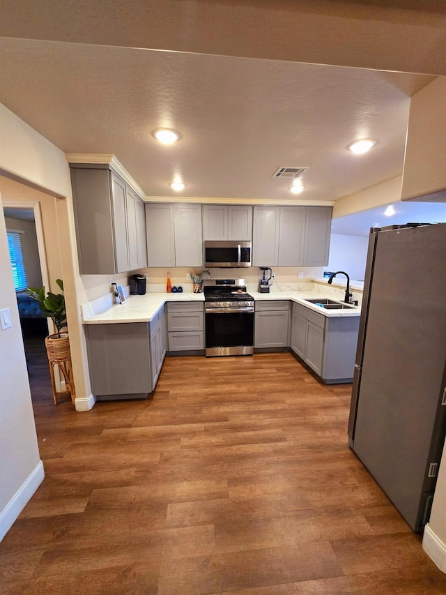 525 N Crenshaw, Visalia, CA 93291 - kitchen with stainless steel appliances, gray cabinets, light countertops, wood finished floors, and recessed lighting