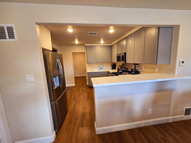 525 N Crenshaw, Visalia, CA 93291 - kitchen with appliances with stainless steel finishes, gray cabinets, dark wood-style flooring, a peninsula, and recessed lighting