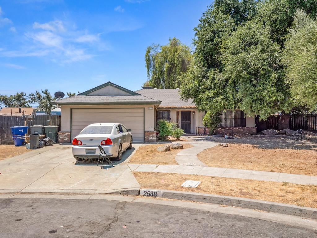 2588 S Sierra Vista Ave, Fresno, CA 93725 - ranch-style house with an attached garage and concrete driveway
