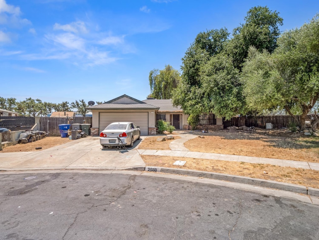 2588 S Sierra Vista Ave, Fresno, CA 93725 - view of front facade with an attached garage and driveway