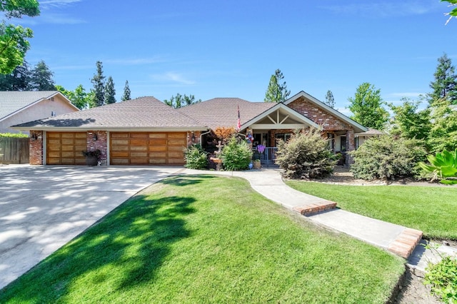 1721 W Wrenwood Ave, Fresno, CA 93711 - view of front of house with a garage, a front yard, concrete driveway, brick siding, and covered porch