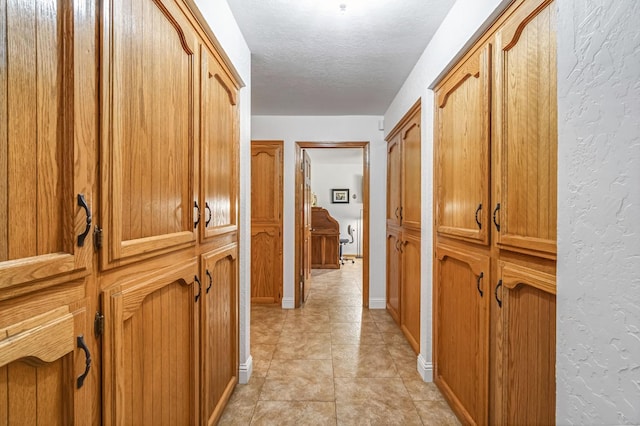 1721 W Wrenwood Ave, Fresno, CA 93711 - hallway with a textured ceiling and a textured wall