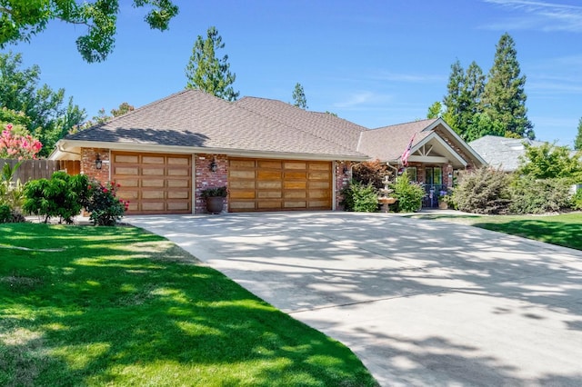 1721 W Wrenwood Ave, Fresno, CA 93711 - view of front of house featuring an attached garage, brick siding, driveway, and roof with shingles