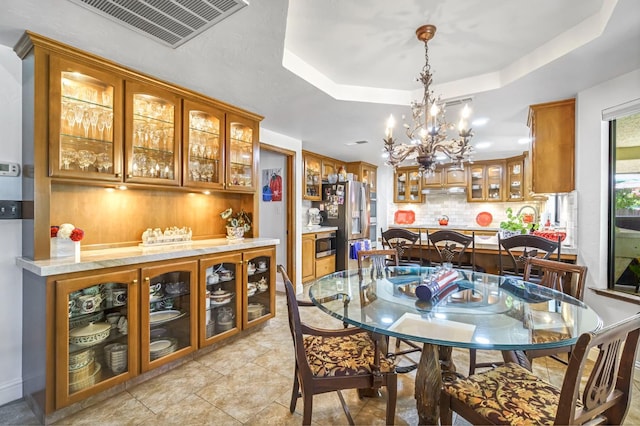 1721 W Wrenwood Ave, Fresno, CA 93711 - dining room with a raised ceiling, a chandelier, and light tile patterned floors