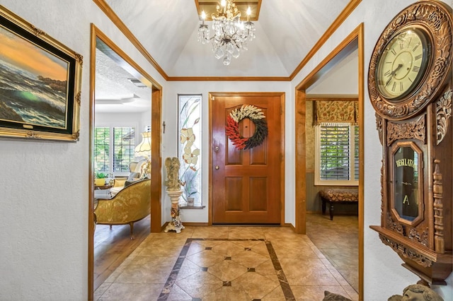 1721 W Wrenwood Ave, Fresno, CA 93711 - entryway with a chandelier, inlaid floor details, a textured wall, vaulted ceiling, and ornamental molding