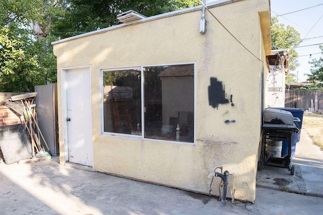 1413 W Fountain Way, Fresno, CA 93705 - view of property exterior featuring stucco siding and a patio area