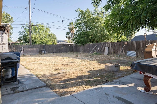 1413 W Fountain Way, Fresno, CA 93705 - fenced backyard with a patio and a fire pit