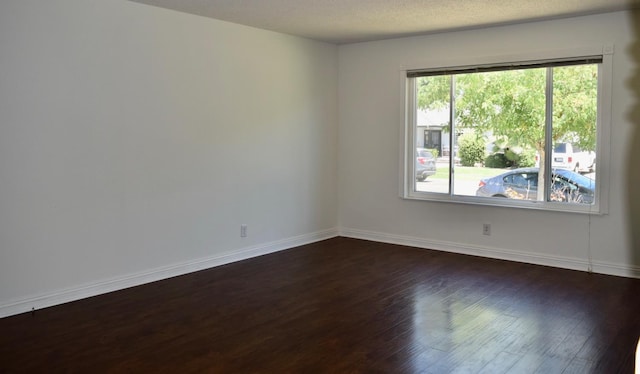 6061 N 9th St, Fresno, CA 93710 - empty room with dark wood-style floors and a textured ceiling