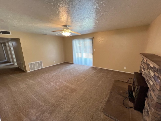 4308 N Cedar Ave, Fresno, CA 93726 - unfurnished living room with ceiling fan, a textured ceiling, carpet flooring, and a stone fireplace