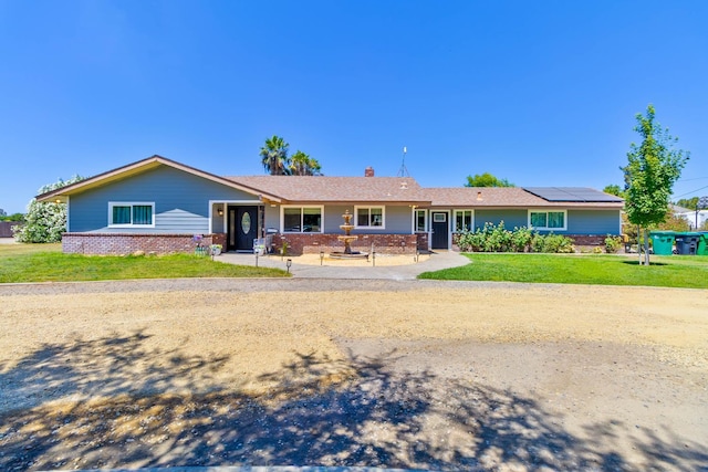 6589 N De Wolf Ave N, Clovis, CA 93619 - ranch-style home featuring a front lawn, roof mounted solar panels, and a chimney