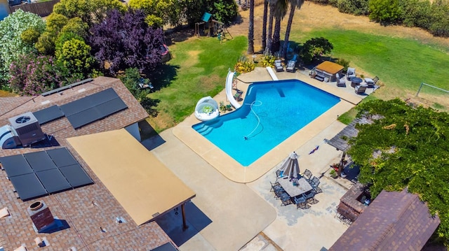 6589 N De Wolf Ave N, Clovis, CA 93619 - view of swimming pool with a water slide, a lawn, and a patio