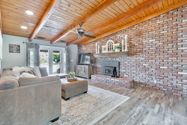 6589 N De Wolf Ave N, Clovis, CA 93619 - living room featuring wood finished floors, brick wall, ceiling fan, a wood stove, and wooden ceiling