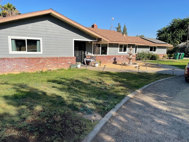 6589 N De Wolf Ave N, Clovis, CA 93619 - view of front facade with brick siding, a front lawn, and a chimney