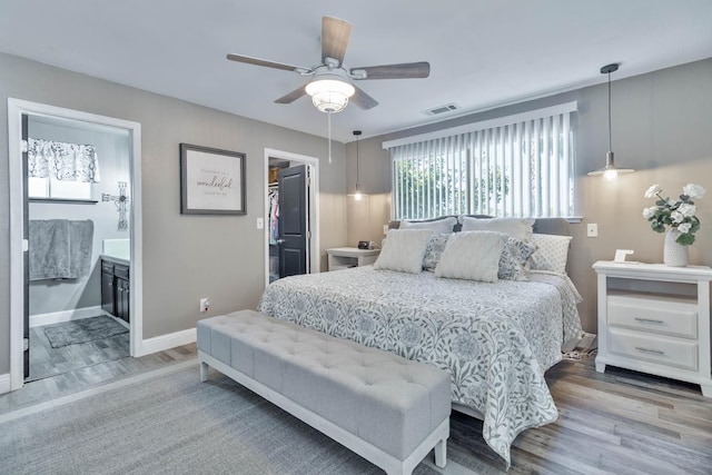 6589 N De Wolf Ave N, Clovis, CA 93619 - bedroom with wood finished floors, a walk in closet, ceiling fan, a closet, and ensuite bathroom