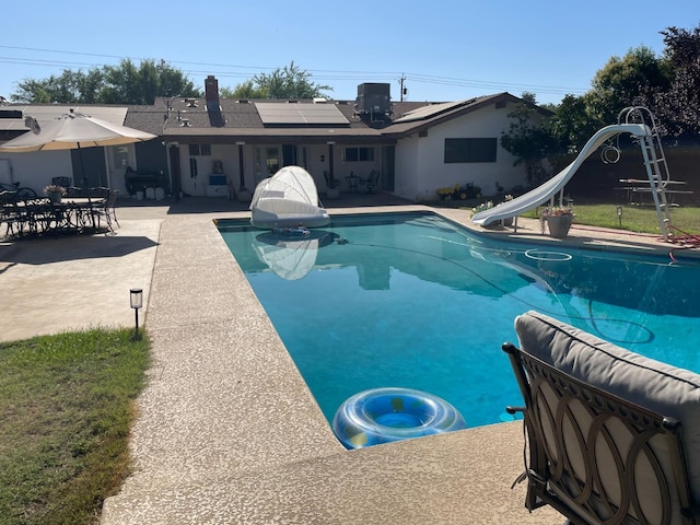 6589 N De Wolf Ave N, Clovis, CA 93619 - outdoor pool with a water slide and a patio area