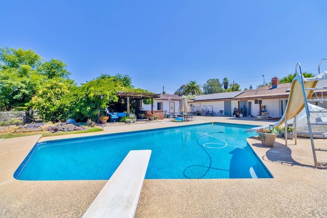 6589 N De Wolf Ave N, Clovis, CA 93619 - outdoor pool with a diving board, a water slide, and a patio