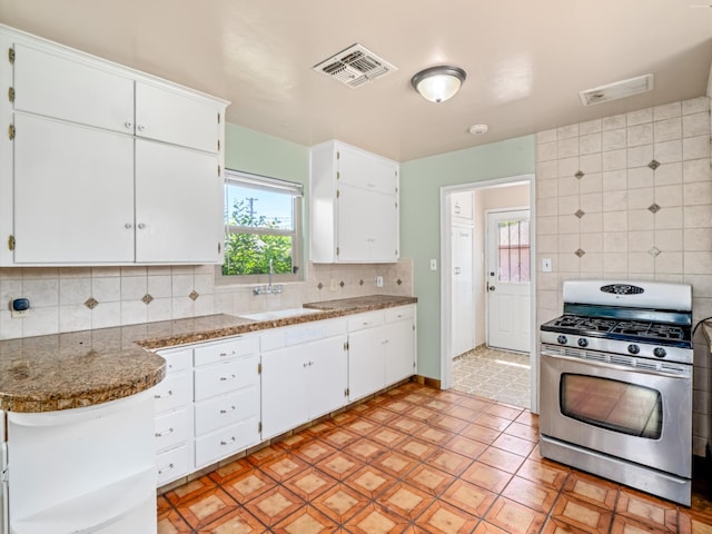 2845 N Adoline Ave, Fresno, CA 93705 - kitchen featuring stainless steel range with gas cooktop, white cabinets, backsplash, and a peninsula