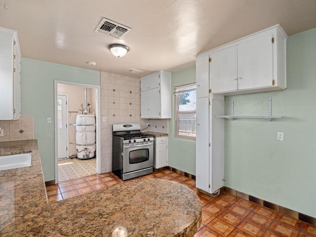 2845 N Adoline Ave, Fresno, CA 93705 - kitchen with gas stove, decorative backsplash, white cabinetry, light tile patterned floors, and a peninsula