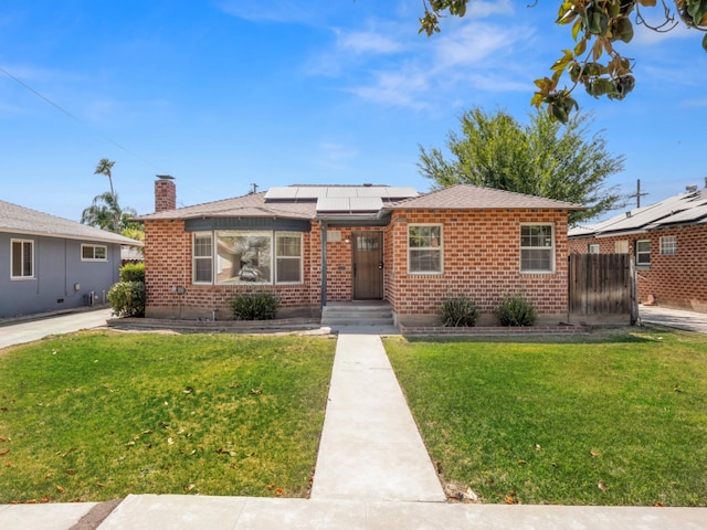 2845 N Adoline Ave, Fresno, CA 93705 - bungalow-style home with roof mounted solar panels, brick siding, and a chimney