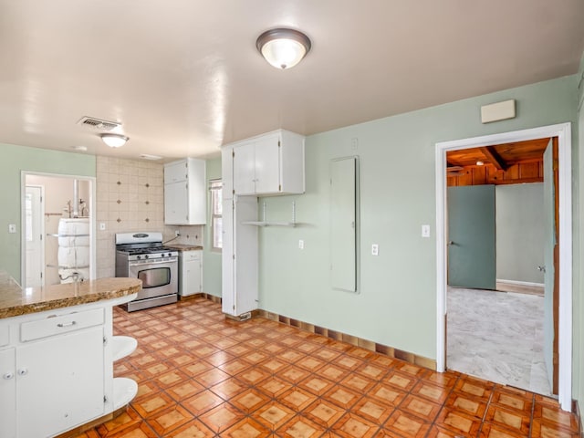 2845 N Adoline Ave, Fresno, CA 93705 - kitchen with gas stove, white cabinetry, tasteful backsplash, and light flooring