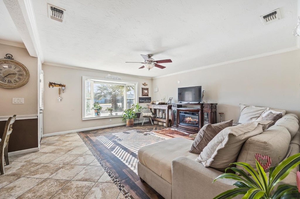 4404 N Eddy Ave, Fresno, CA 93727 - living room with crown molding, ceiling fan, and light stone finish flooring