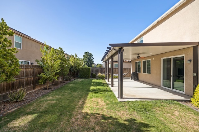 7141 N Shiraz Ave, Fresno, CA 93722 - fenced backyard featuring ceiling fan and a patio area