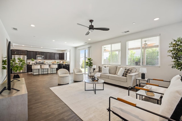 7141 N Shiraz Ave, Fresno, CA 93722 - living area featuring recessed lighting, dark wood-style flooring, and a ceiling fan