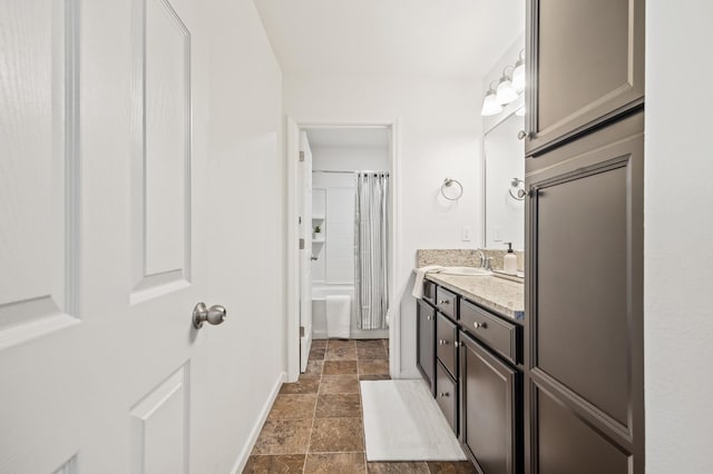 7141 N Shiraz Ave, Fresno, CA 93722 - bathroom featuring vanity, stone finish flooring, and shower / tub combo