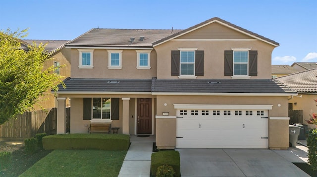 7141 N Shiraz Ave, Fresno, CA 93722 - traditional home with stucco siding, driveway, and a garage