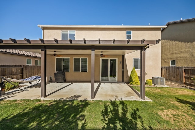 7141 N Shiraz Ave, Fresno, CA 93722 - back of property featuring ceiling fan, stucco siding, and a fenced backyard