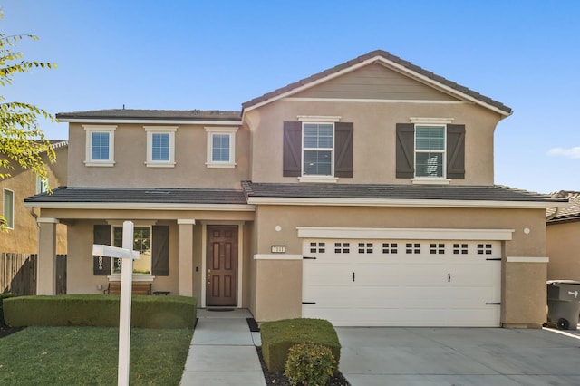 7141 N Shiraz Ave, Fresno, CA 93722 - traditional-style home with driveway, an attached garage, stucco siding, covered porch, and a tiled roof