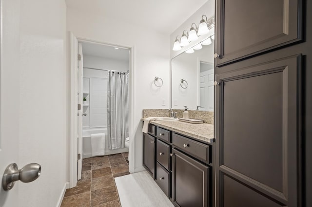 7141 N Shiraz Ave, Fresno, CA 93722 - bathroom with vanity, stone finish flooring, and shower / bath combo