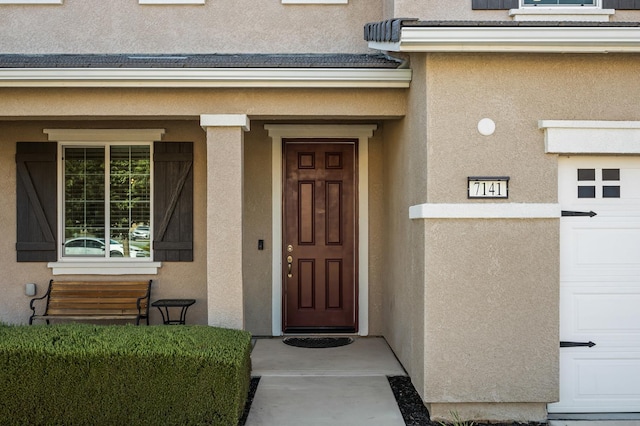 7141 N Shiraz Ave, Fresno, CA 93722 - doorway to property featuring stucco siding and a porch