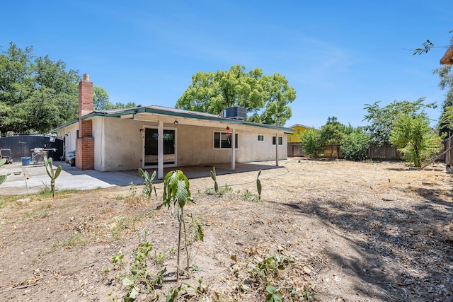 3318 Stanford Ave, Clovis, CA 93611 - rear view of house with a fenced backyard, a chimney, a patio, and stucco siding