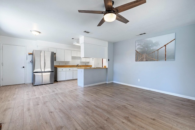 3318 Stanford Ave, Clovis, CA 93611 - kitchen featuring freestanding refrigerator, white cabinetry, light wood-style flooring, a ceiling fan, and a peninsula