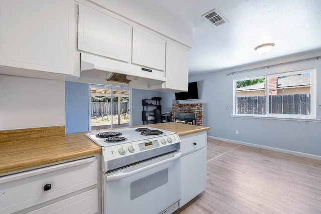 3318 Stanford Ave, Clovis, CA 93611 - kitchen featuring white range with electric cooktop, light countertops, white cabinetry, and under cabinet range hood