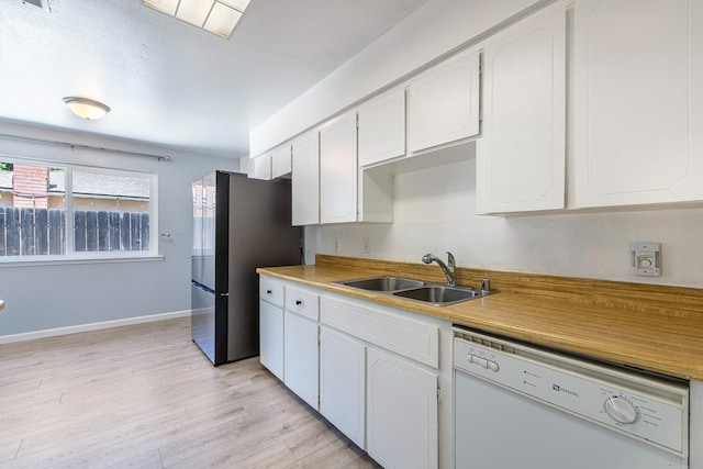 3318 Stanford Ave, Clovis, CA 93611 - kitchen with white dishwasher, freestanding refrigerator, white cabinetry, and light wood-style floors